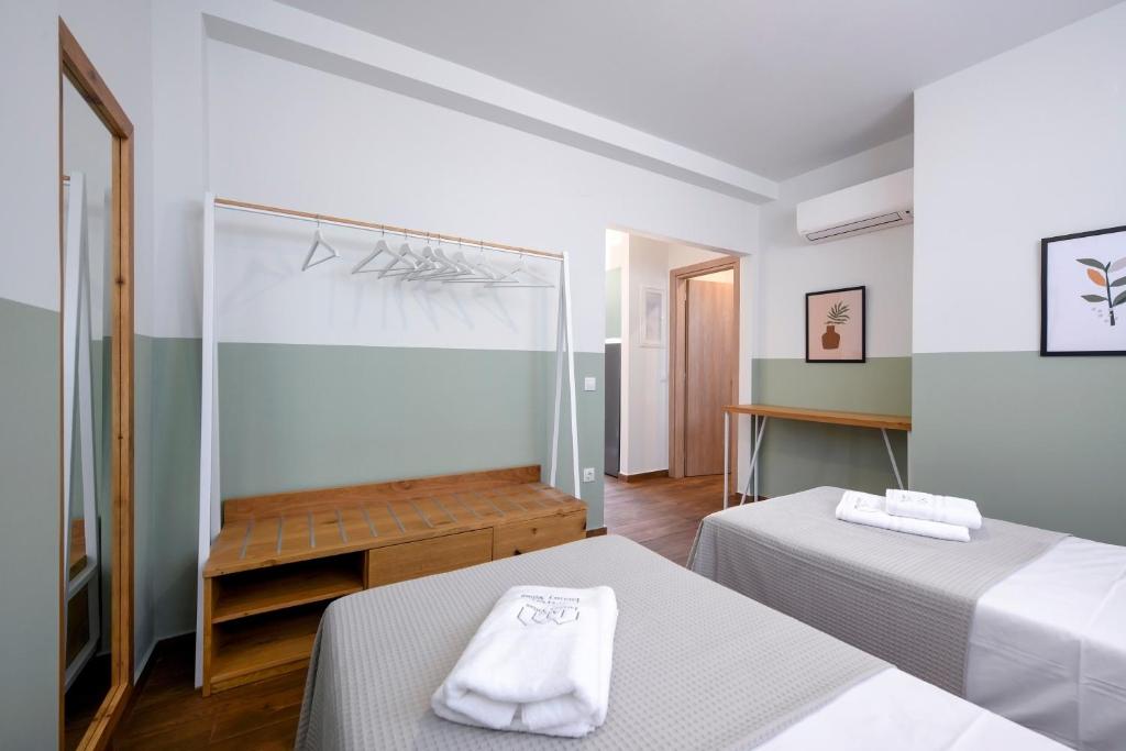 a hotel room with two beds and a mirror at AG Luxury Villas, Iraklitsa in Iraklitsa