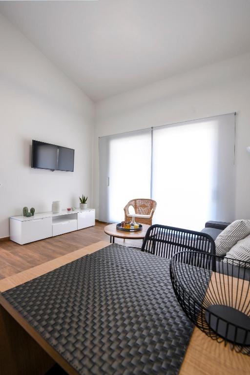 a living room with a couch and a table at AG Luxury Villas, Iraklitsa in Iraklitsa
