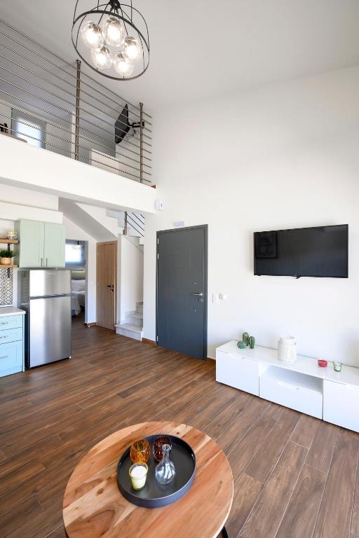 a living room with a table and a kitchen at AG Luxury Villas, Iraklitsa in Iraklitsa