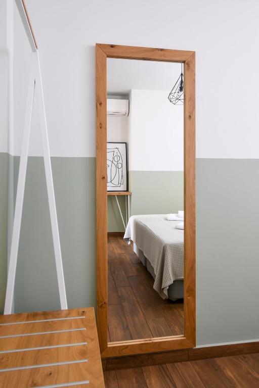 a mirror in a room with a bed at AG Luxury Villas, Iraklitsa in Iraklitsa