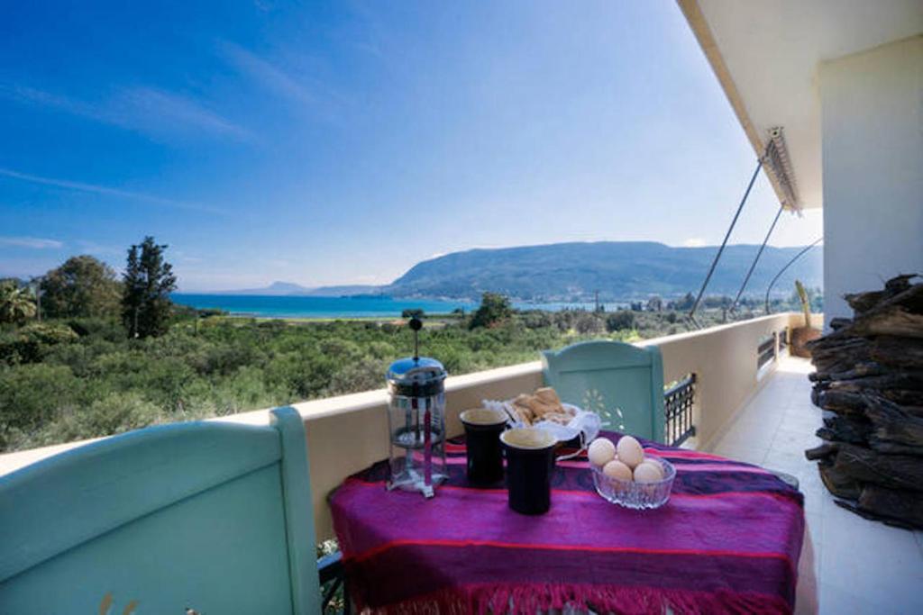 a table on a balcony with a view of the ocean at Sea view Penthhouse in Souda