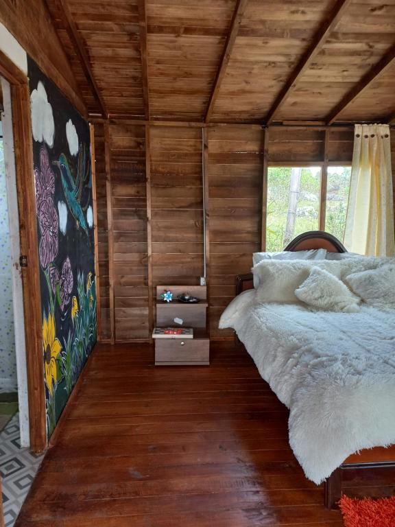 Postel nebo postele na pokoji v ubytování Cabaña Sueños Dorados