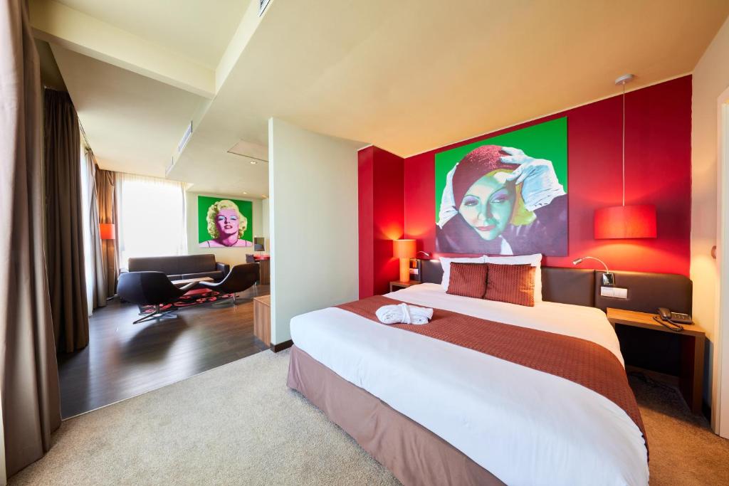 a hotel room with a large bed with red walls at Clarion Congress Hotel Bratislava in Bratislava