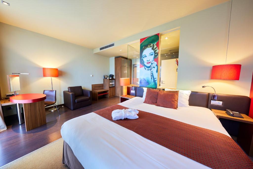 a hotel room with a large bed in a room at Clarion Congress Hotel Bratislava in Bratislava