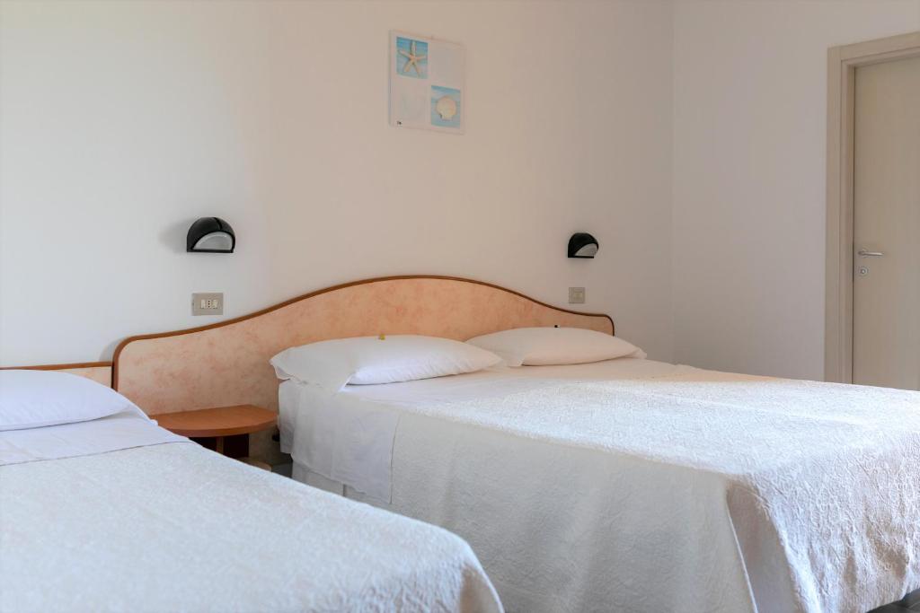 Postel nebo postele na pokoji v ubytování Hotel Apollo
