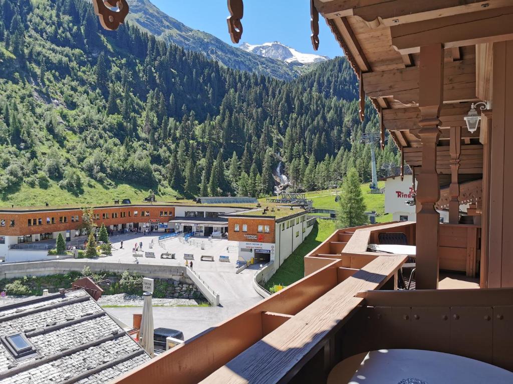 a view from the balcony of a ski resort with a mountain at Hotel Neuhintertux in Tux