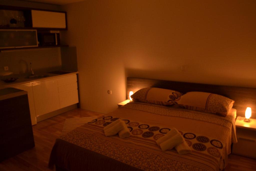 a bedroom with a bed with lights on it at Kalelarga 4 You Apartments in Zadar