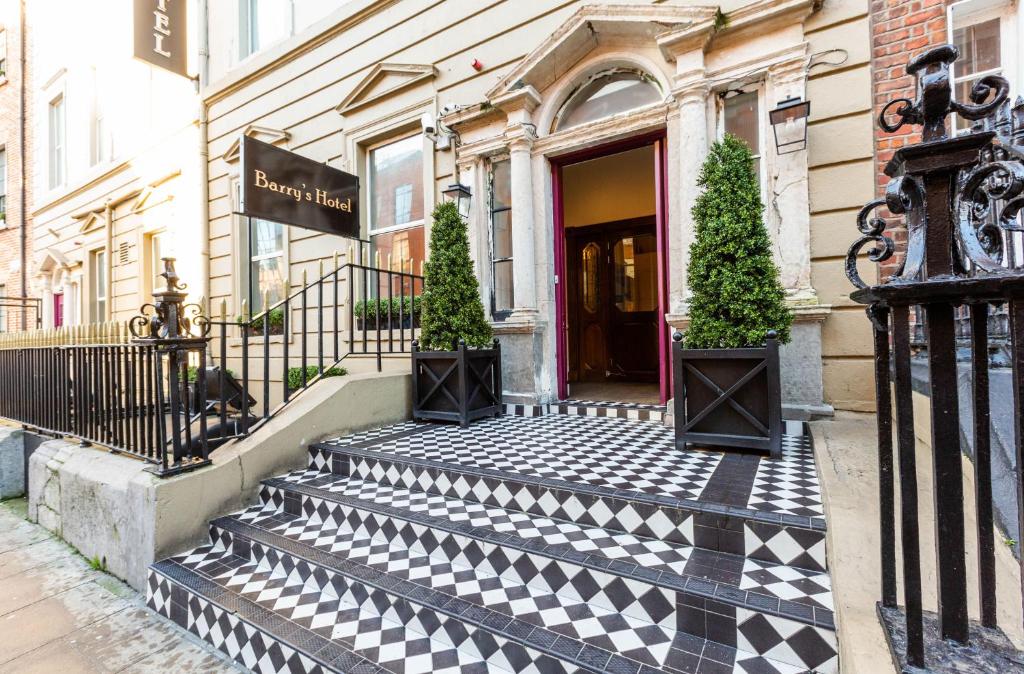 a building with a black and white checkered walkway at Barry's Hotel in Dublin