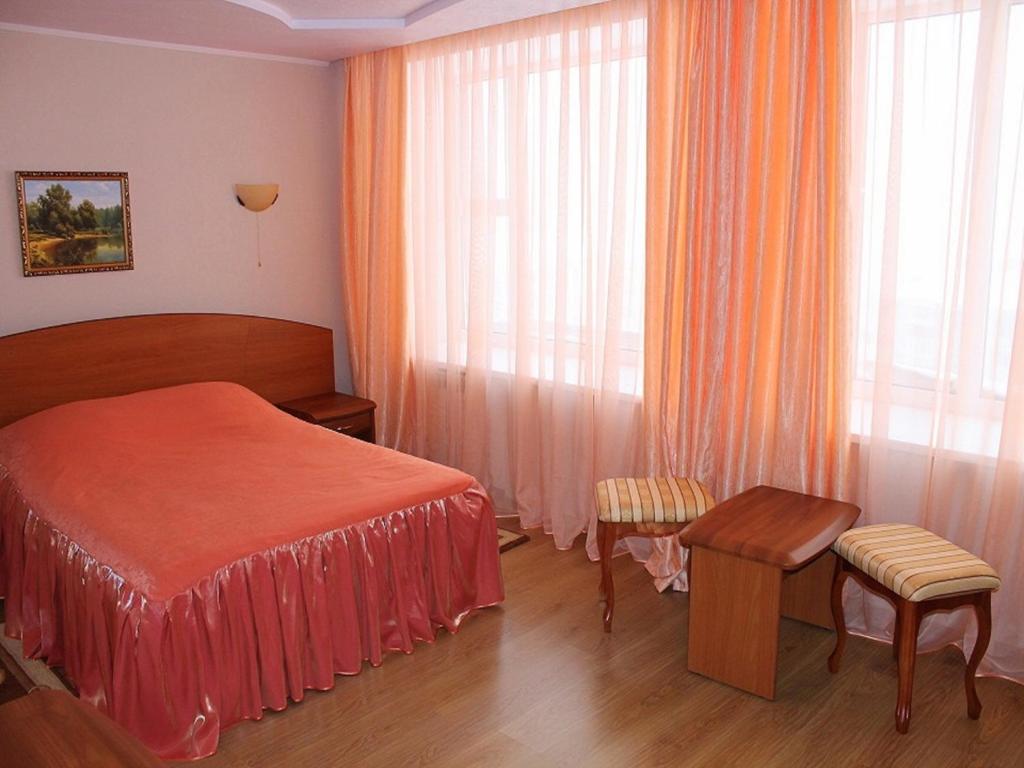 a hotel room with a bed and a window at Vorkuta Hotel in Vorkuta