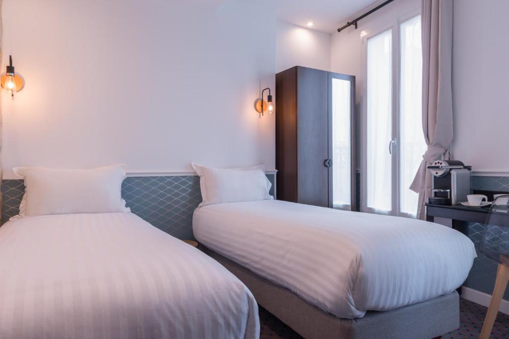 Postel nebo postele na pokoji v ubytování Hôtel Tilde