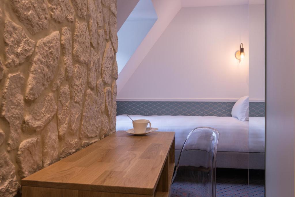 Postel nebo postele na pokoji v ubytování Hôtel Tilde
