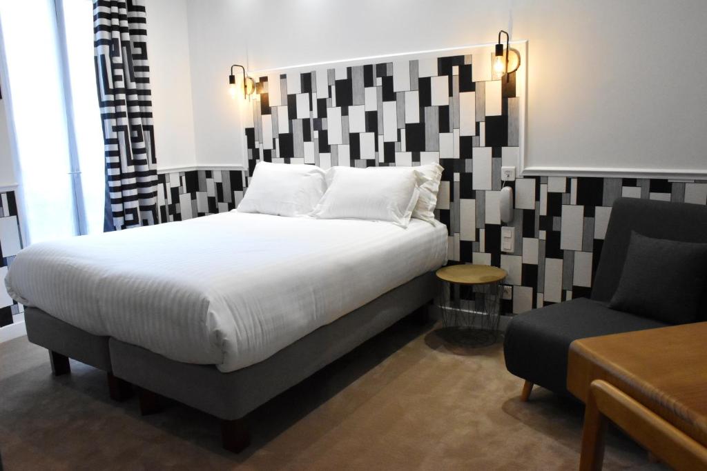 Postel nebo postele na pokoji v ubytování Hôtel Tilde