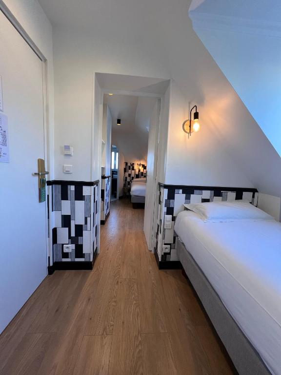 Postel nebo postele na pokoji v ubytování Hôtel Tilde