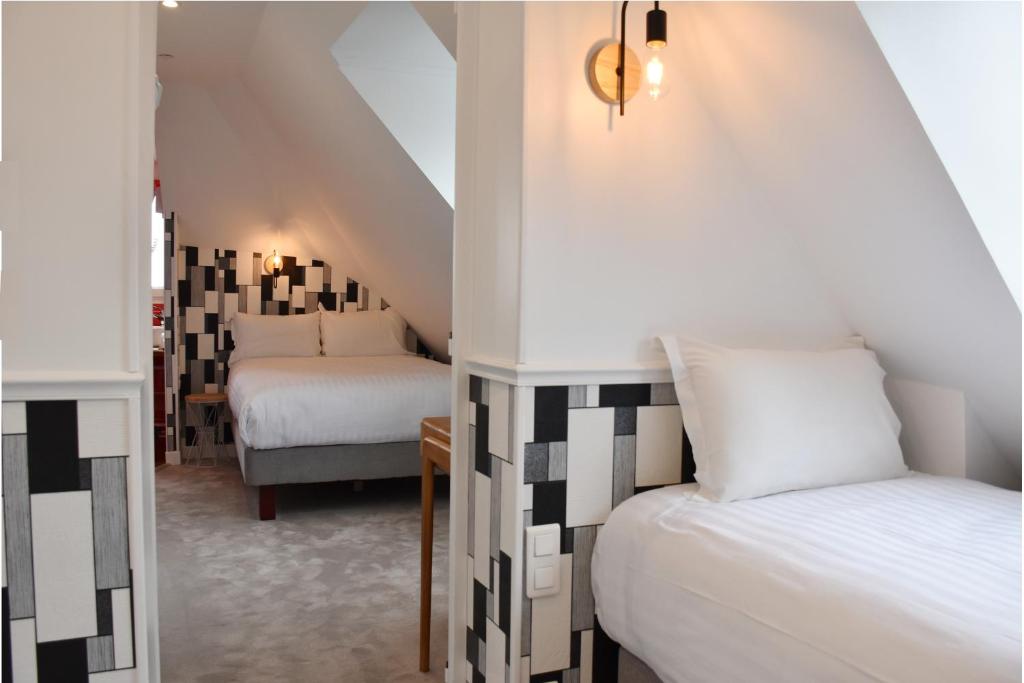 Postel nebo postele na pokoji v ubytování Hôtel Tilde