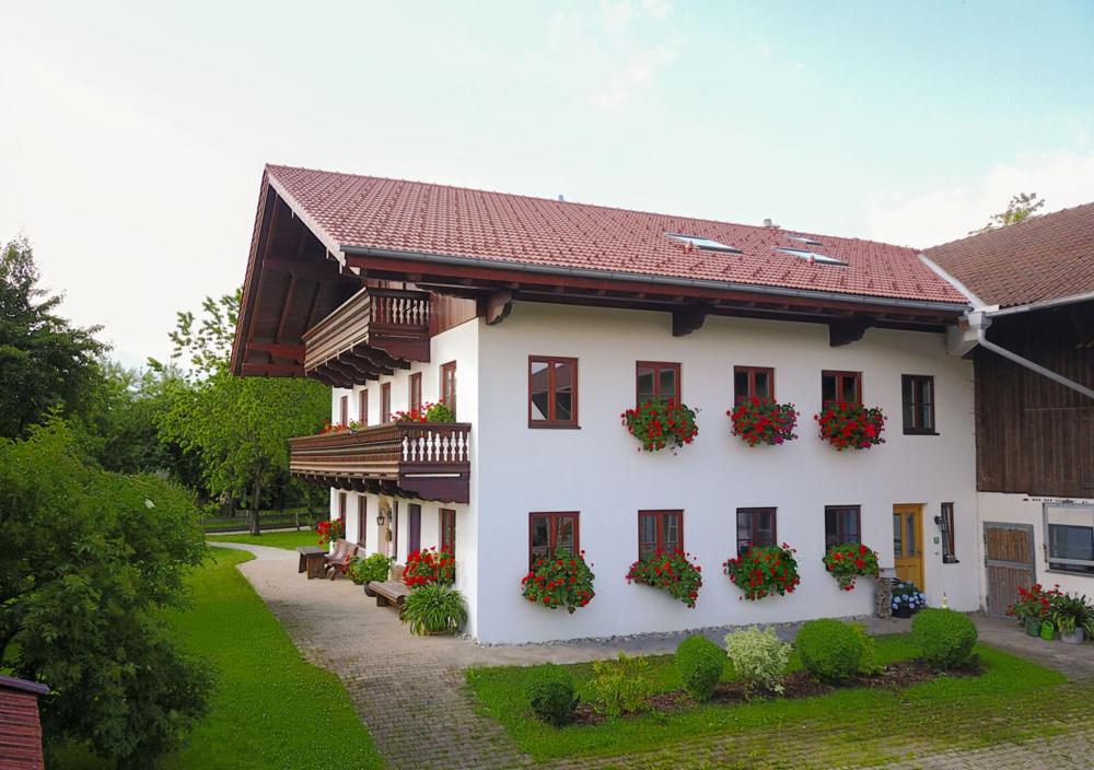 a white building with flower boxes on the windows at Fewo B33 in Übersee