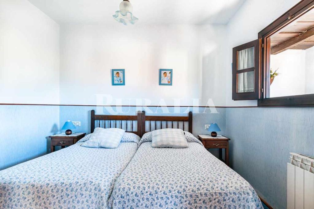A bed or beds in a room at Casa Carmen 5 Situada en una zona muy tranquila a