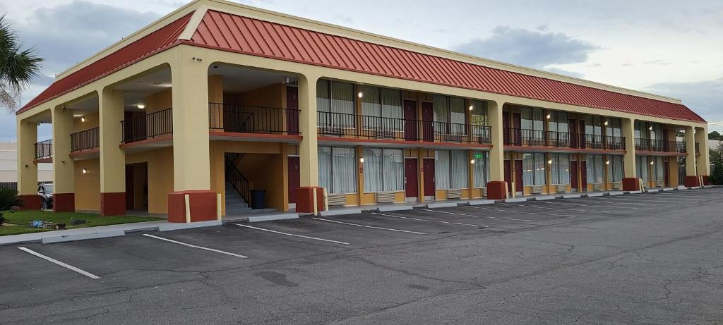 a large building with a lot of windows in a parking lot at Red Roof Inn Tifton in Tifton