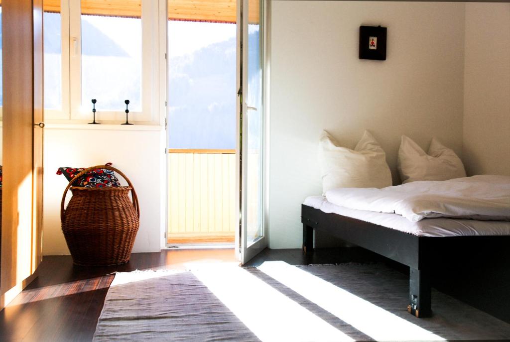 a bedroom with a bed and a large window at Hugo & Rosa -Huusa im Bregenzerwald in Egg