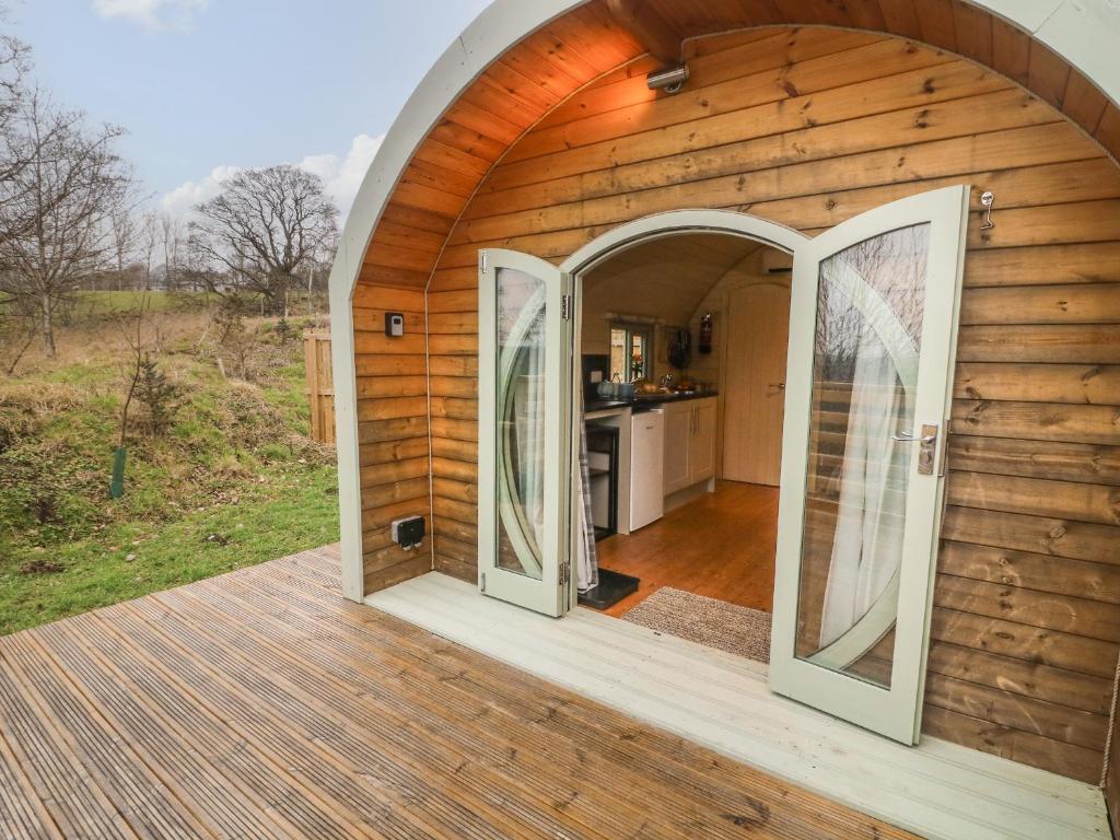 an arched doorway to a hobbit house with a kitchen at Badger in Keighley