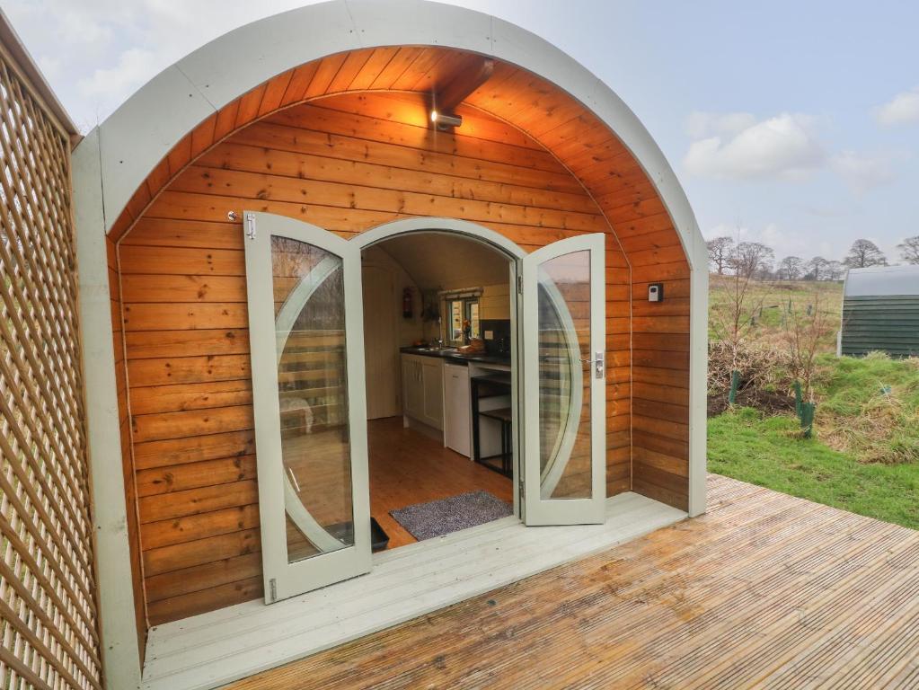 an arched entrance to a wooden house with an archway at Fox in Keighley