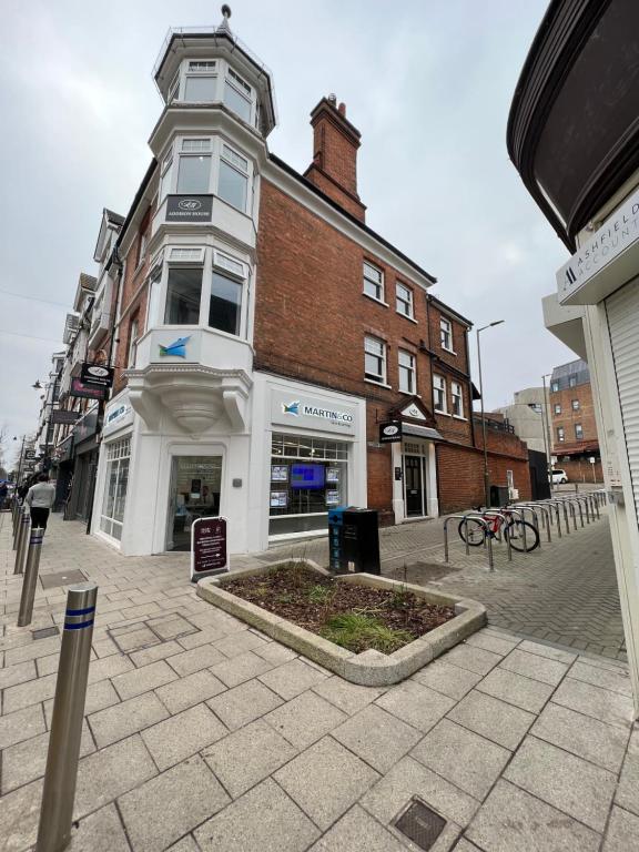 a building on a city street with a building at Addison House in Woking