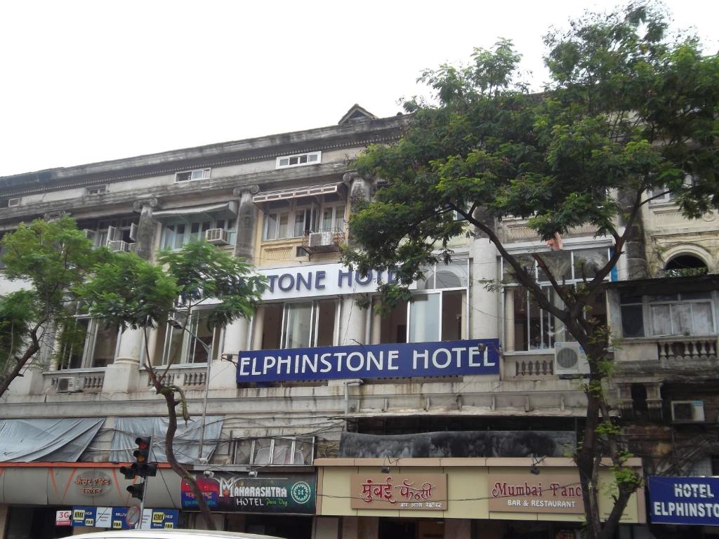 a building with a sign on the side of it at Elphinstone Hotel in Mumbai