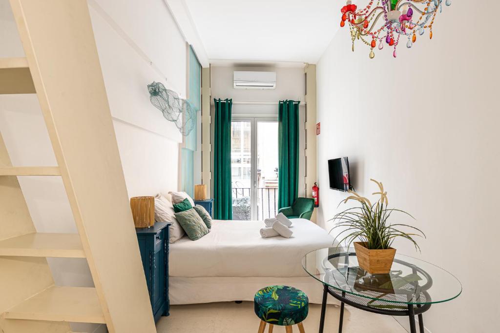 a living room with a white couch and a glass table at BNBHolder Oasis GRAN VIA in Madrid