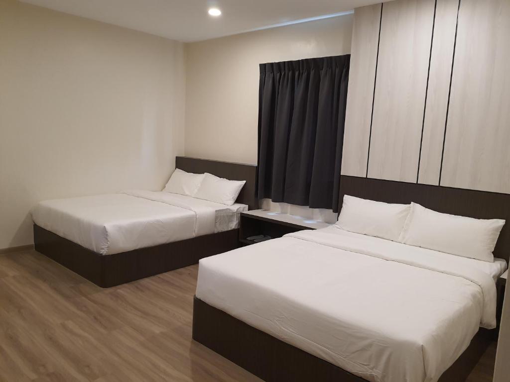 Postel nebo postele na pokoji v ubytování T SQUARE HOTEL (IPOH)