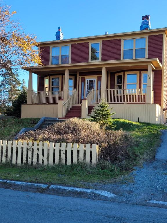 a house with a fence in front of it at The Harbourside Inn & Cafe in Port Union