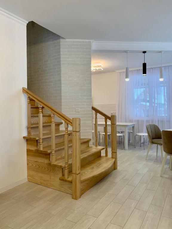 a staircase in a room with a table and chairs at Котедж Макс in Slavske