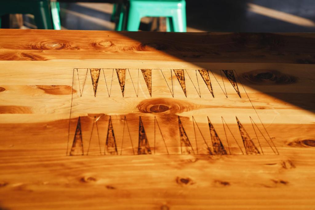 a close up of a wooden table with nails on it at Waypoint Hotel in Bend
