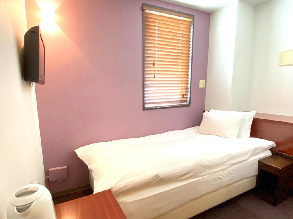 a bedroom with a white bed and a window at WEB Hotel Tokyo Asakusabashi - Vacation STAY 13758v in Tokyo