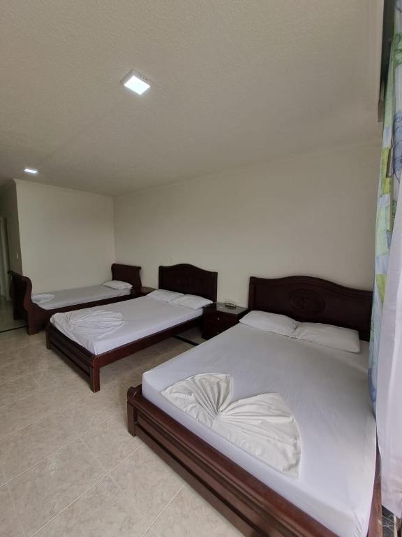 Postel nebo postele na pokoji v ubytování Zahira Hotel Melgar