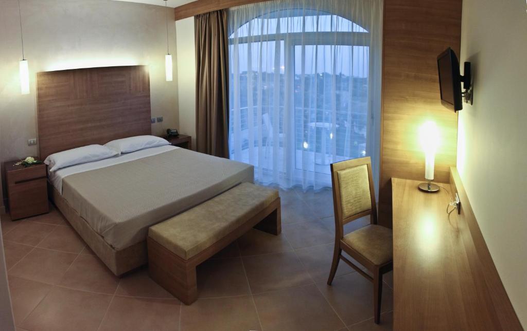 Postel nebo postele na pokoji v ubytování Hotel Vespucci