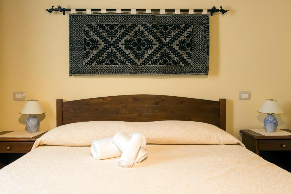 Postel nebo postele na pokoji v ubytování Albergo Diffuso Il Mandorlo