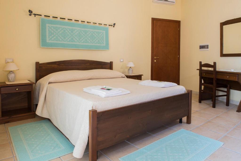 Postel nebo postele na pokoji v ubytování Albergo Diffuso Il Mandorlo