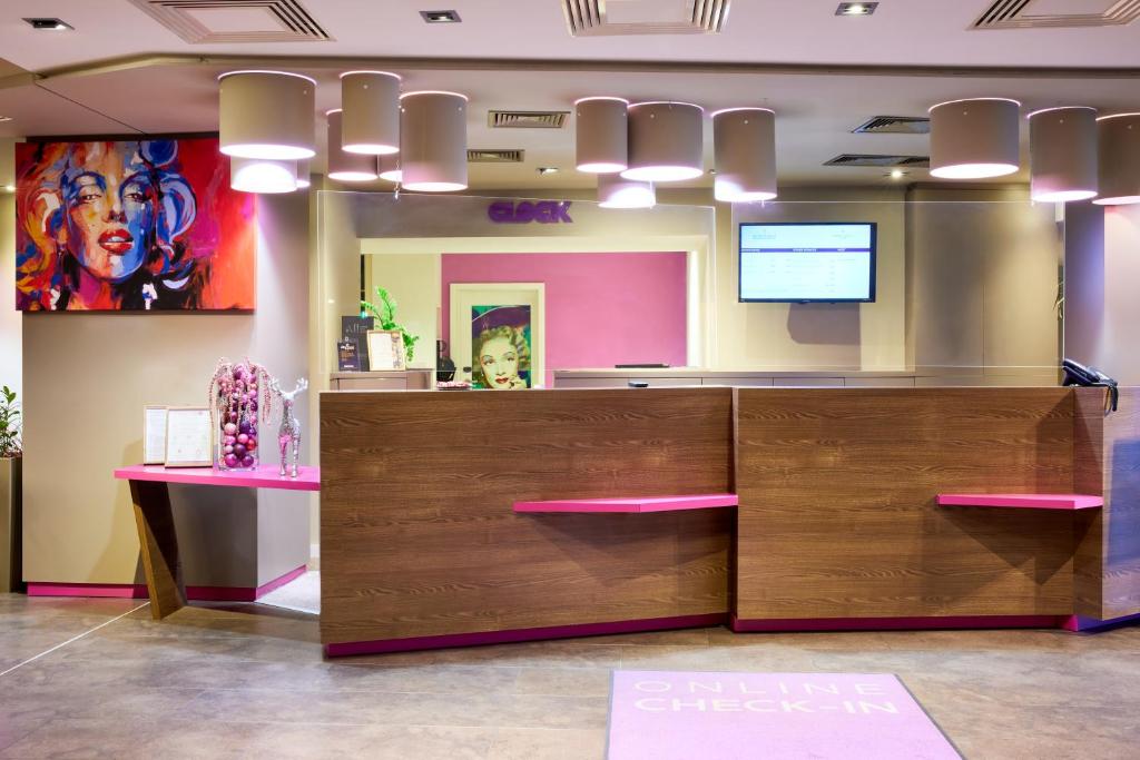 a reception area of a salon with a large wooden reception desk at Clarion Congress Hotel Bratislava in Bratislava