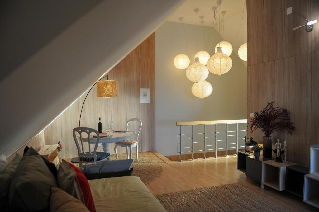 a living room with a couch and a table at Casa Centenária Povoa Nova in Seia