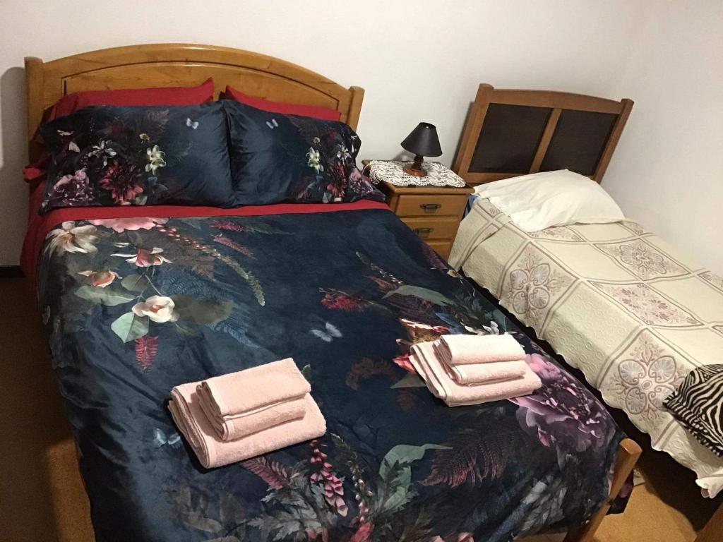 a bedroom with a bed with two towels on it at Casa J Dias in Nordeste