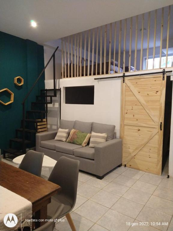 a living room with a couch and a sliding door at Mio Amore Tigre - C in Tigre