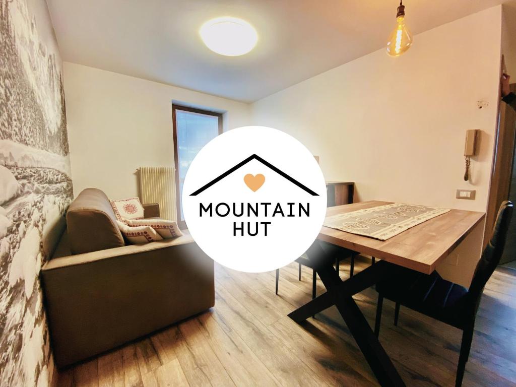 a room with a table and a chair and a bed at Mountain Hut Veronza in Cavalese