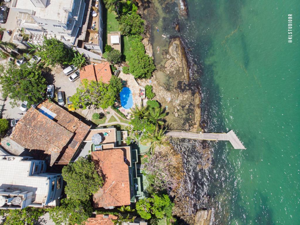 an aerial view of a house next to the ocean at Pousada Praia da Lagoinha in Bombinhas