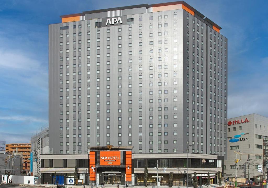 a large building with a large clock on the side of it at APA Hotel & Resort Niigata Ekimae Odori in Niigata