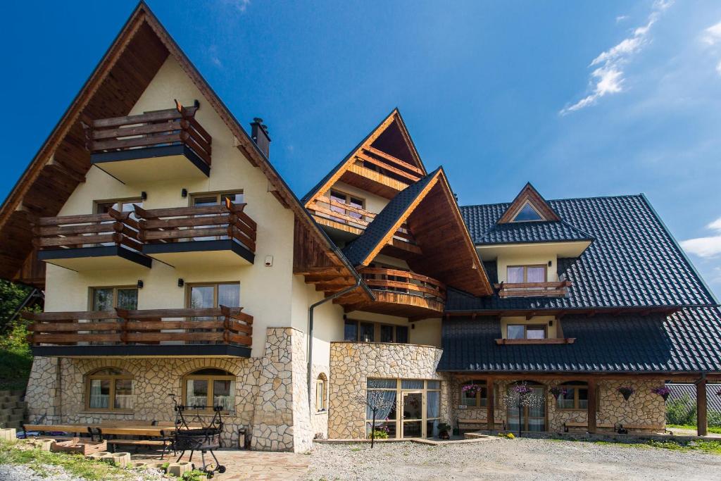 a large house with wooden balconies on it at Willa u Bohuna in Zakopane