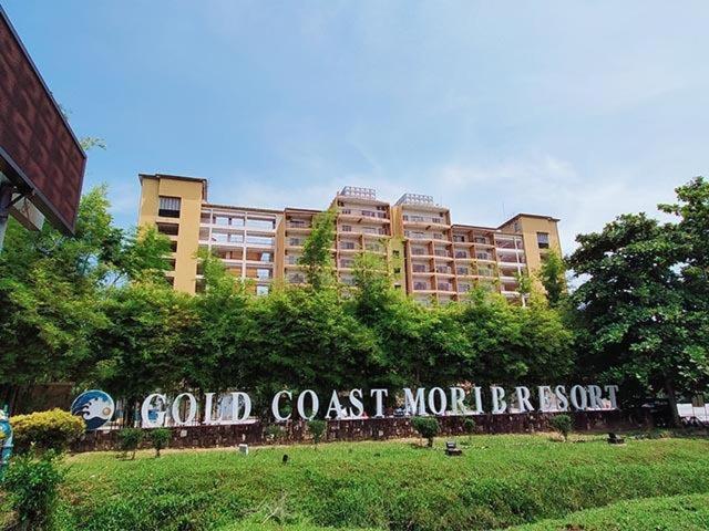 a sign in front of a large building at Buluh Inn @ Gold Coast Morib in Banting