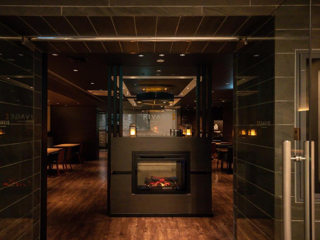 a fireplace in the middle of a room at HOTEL MYSTAYS Shin Osaka Conference Center in Osaka