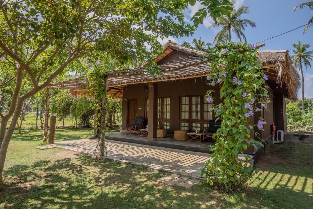 a view of a house from the garden at Club Mango Resort in Kalpitiya