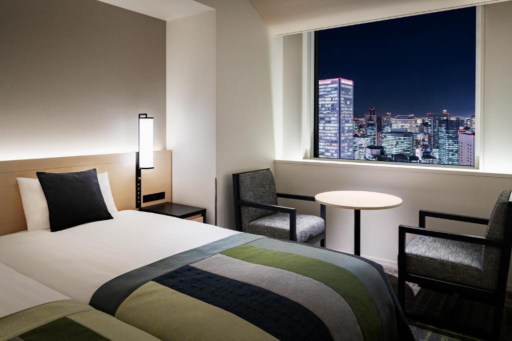 Postel nebo postele na pokoji v ubytování Hotel Hankyu RESPIRE OSAKA