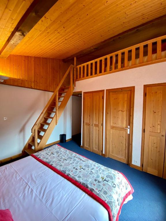 a bedroom with a bunk bed and a staircase at Hotel Les Bruyères in Morzine
