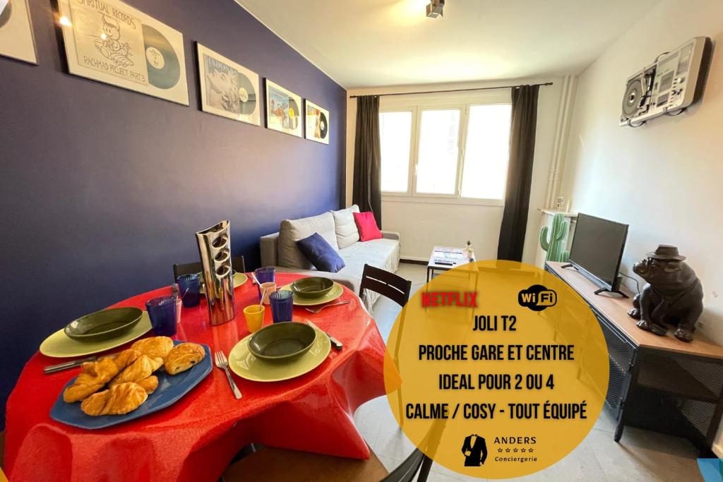 a room with a red table with plates of food on it at La Loge - Joli T2 proche Longchamp / Centre-ville et Gare - Wifi Netflix in Marseille